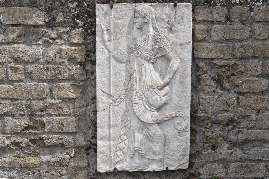 Herculaneum, April 2018. Reproduction relief of Minerva from the shrine of Four Gods on the Sacred Area terrace.
Photo courtesy of Ian Lycett-King. Use is subject to Creative Commons Attribution-NonCommercial License v.4 International.